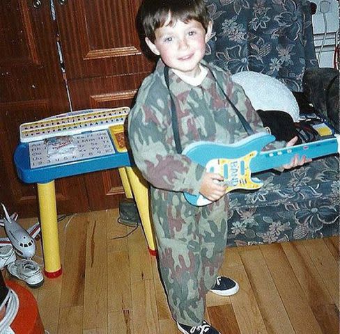 <p>Niall Horan Instagram</p> Niall Horan playing a toy guitar as a child