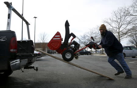 Corey Ihasz of Potomac, Maryland loads his new snow blower into his truck at the Lowe's store in Kentlands, Maryland January 21, 2016. REUTERS/Gary Cameron