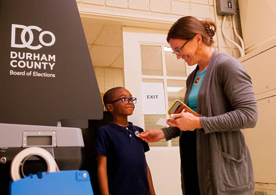 Laura Klein puts a sticker on Prince Witkins, 6, after voting at White Rock Baptist Church in Durham, N.C. on Tuesday, March 5, 2024.