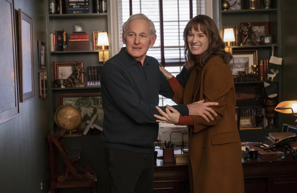 This image released by Hulu shows Victor Garber, left, and Mackenzie Davis in a scene from "Happiest Season." (Lacey Terrell/Hulu via AP)