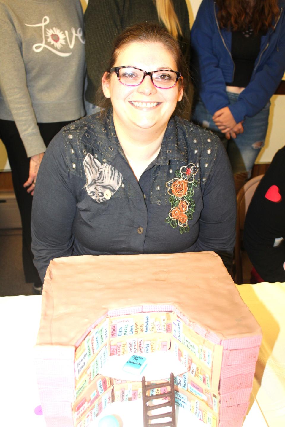 Miranda Durst's first-place tie cake called "OMG. It's a Library Cake" was sold for $190 to Glenda Shultz at the Death By Chocolate event in Meyersdale on Friday evening.