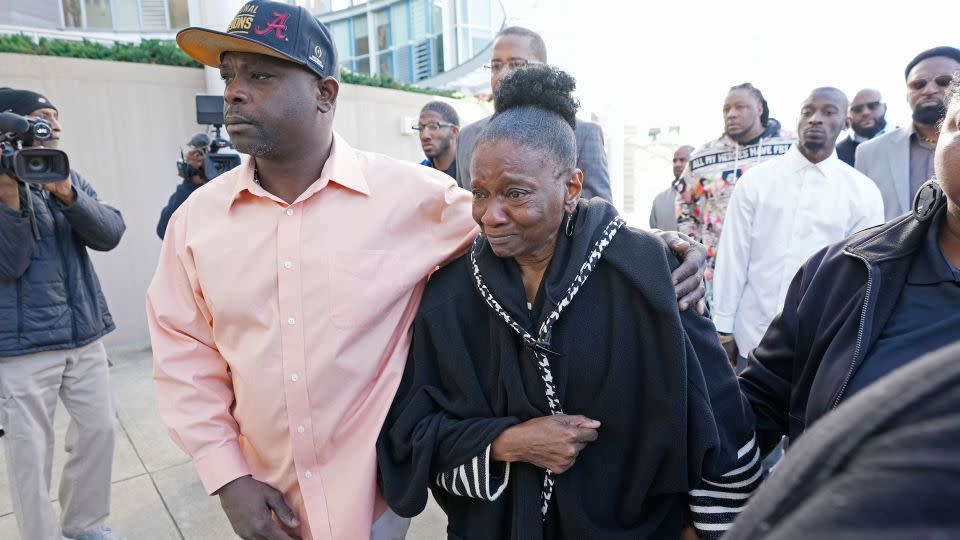 Eddie Terrell Parker, left, escorts Mary Jenkins, mother of Michael Corey Jenkins, into the Thad Cochran United States Courthouse in Jackson, Mississippi, on Tuesday. - Rogelio V. Solis/AP