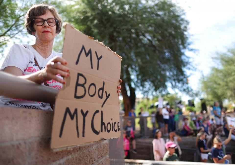 PHOTO: A protestor holds a sign reading 'My Body My Choice' at a Women's March rally where Arizona Secretary of State and Democratic gubernatorial candidate Katie Hobbs spoke outside the State Capitol on October 8, 2022 in Phoenix, Arizona. (Mario Tama/Getty Images)