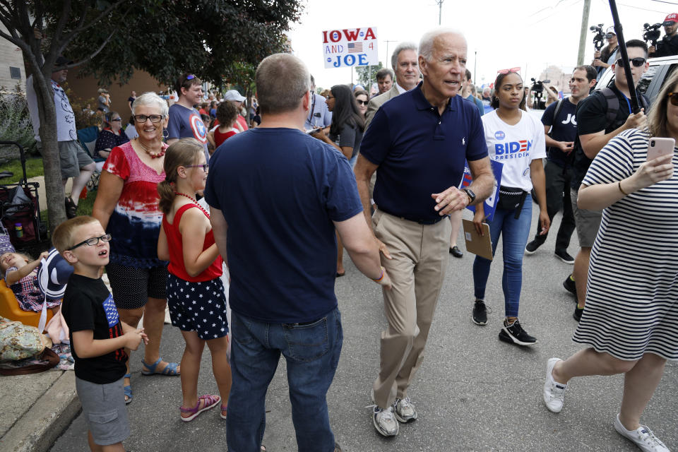 Former vice president and Democratic presidential candidate Joe Biden greets local residents while walking in the Independence Fourth of July parade, Thursday, July 4, 2019, in Independence, Iowa. (AP Photo/Charlie Neibergall)