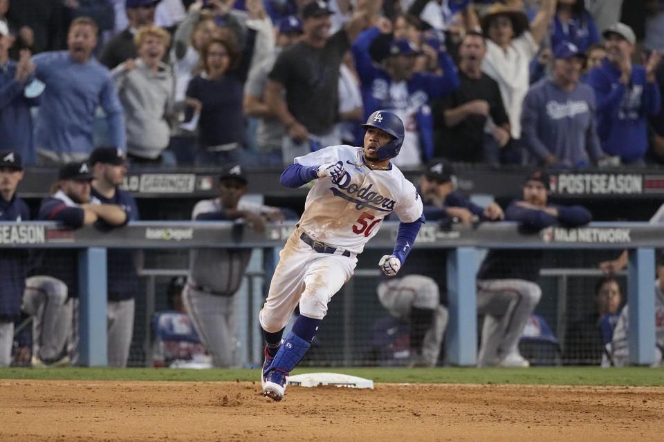 Los Angeles Dodgers' Mookie Betts rounds first base after hitting an RBI double in the eighth inning against the Atlanta Braves in Game 3 of baseball's National League Championship Series Tuesday, Oct. 19, 2021, in Los Angeles. (AP Photo/Marcio Jose Sanchez)