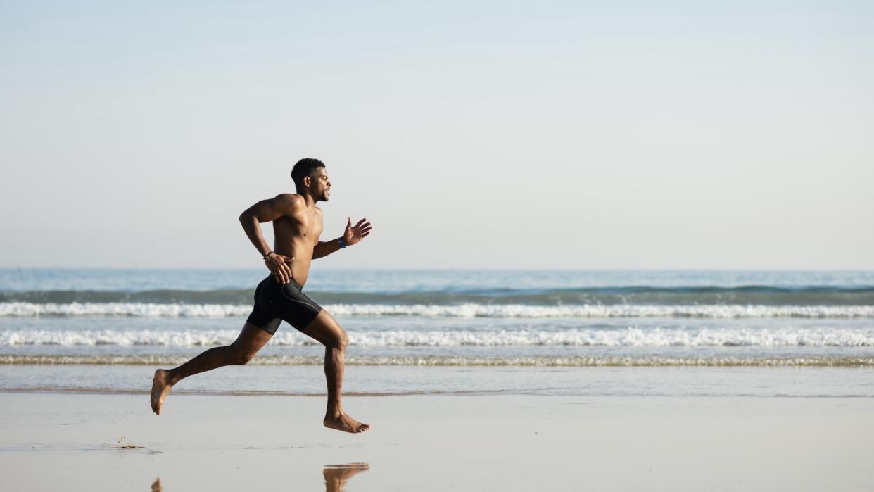  Man running on beach. 