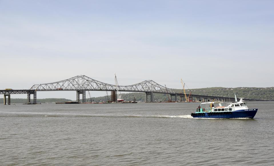 A boat ferries construction workers to and from the construction site of a new bridge to replace the 58-year-old Tappan Zee Bridge spanning the Hudson River, Tuesday, May 13, 2014, between Tarrytown and Nyack, N.Y. On Wednesday, President Barack Obama plans to speak by the bridge just north of New York City to press his case that a key federal government fund used to pay for the nation's roads, bridges and ports is running dry and that the economy would be damaged if it is not replenished. (AP Photo/Julie Jacobson)