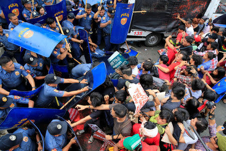 Various activist and Indigenous People's (IP) groups clash with anti-riot policemen during a protest against the continuing presence of U.S. troops in the Philippines in front of the U.S. Embassy in metro Manila, Philippines October 19, 2016. REUTERS/Romeo Ranoco