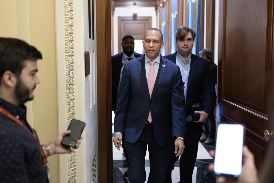 House Minority Leader Hakeem Jeffries in the halls of Congress with several others..