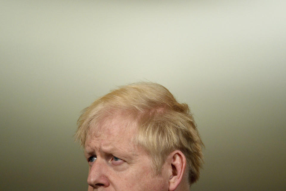 Britain's Prime Minister Boris Johnson pauses, during a coronavirus media briefing in Downing Street, London, Tuesday, Oct. 20, 2020. British Prime Minister Boris Johnson says he is imposing the highest level of coronavirus restrictions on the Greater Manchester region, after days-long negotiations between his government and local leaders who reject the measures broke down with no deal reached. (Leon Neal/Pool Photo via AP)