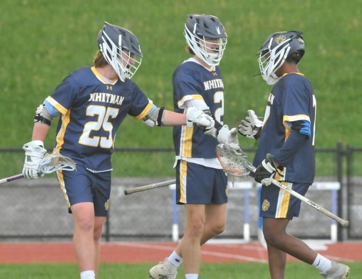 Rylan Weissinger, left, Connor Tomion, center and Melkamu Blueye celebrate a Marcus Whitman goal during Tuesday's game at Bloomfield/Honeoye.
