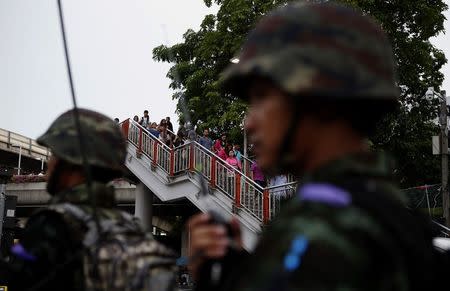 Residents look at soldiers guarding the vicinity of Victory Monument in Bangkok June 2, 2014. REUTERS/Erik De Castro