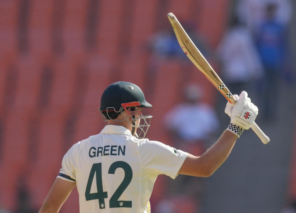 Australia's Cameron Green raises his bat to celebrate scoring a half century during the second day of the fourth cricket test match between India and Australia in Ahmedabad, India, Friday, March 10, 2023. (AP Photo/Ajit Solanki)