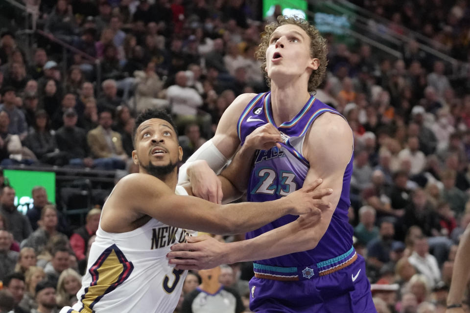 New Orleans Pelicans guard CJ McCollum (3) and Utah Jazz forward Lauri Markkanen (23) battle for position under the boards during the first half of an NBA basketball game Thursday, Dec. 15, 2022, in Salt Lake City. (AP Photo/Rick Bowmer)