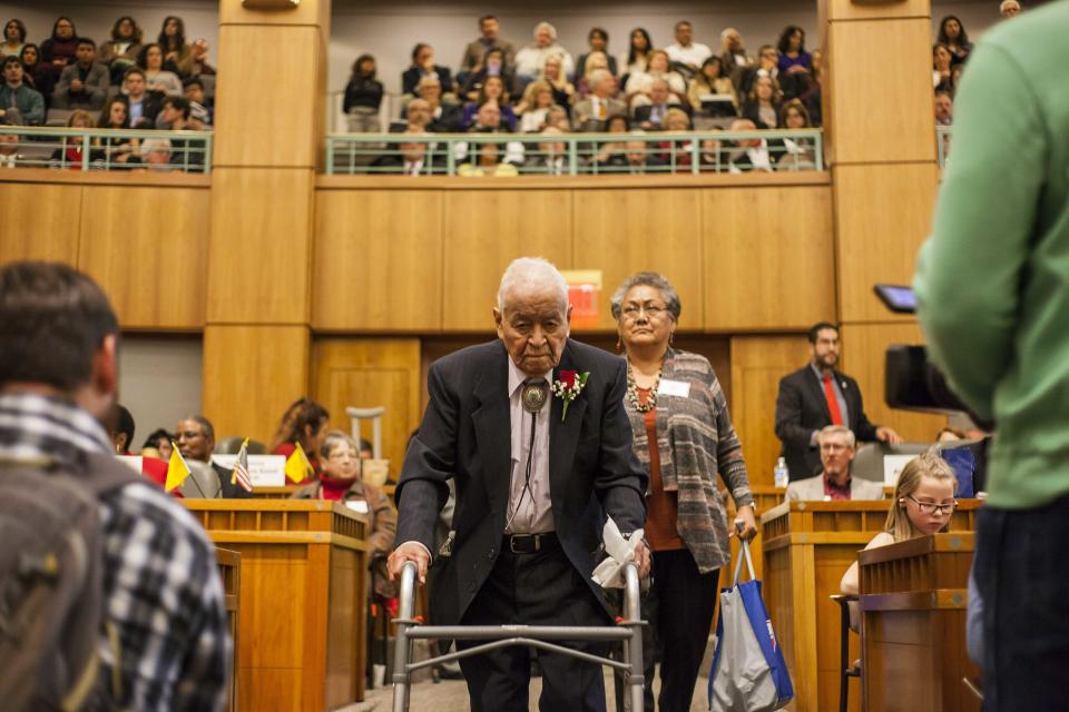 FILE - This Jan. 16, 2018, file photo Sen. John Pinto enters the House chambers on the first day of the New Mexico Legislature at the New Mexico Capitol in Santa Fe, N.M. Pinto, one of the nation's longest serving Native American elected officials, has died at age 94. (AP Photo/Juan Labreche,File)