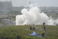 Participants playing the role of terrorists attack a United Nations base during the Shared Destiny 2021 drill at the Queshan Peacekeeping Operation training base in Queshan County in central China's Henan province Wednesday, Sept. 15, 2021. Peacekeeping troops from China, Thailand, Mongolia and Pakistan took part in the 10 days long exercise that field reconnaissance, armed escort, response to terrorist attacks, medical evacuation and epidemic control. (AP Photo/Ng Han Guan)