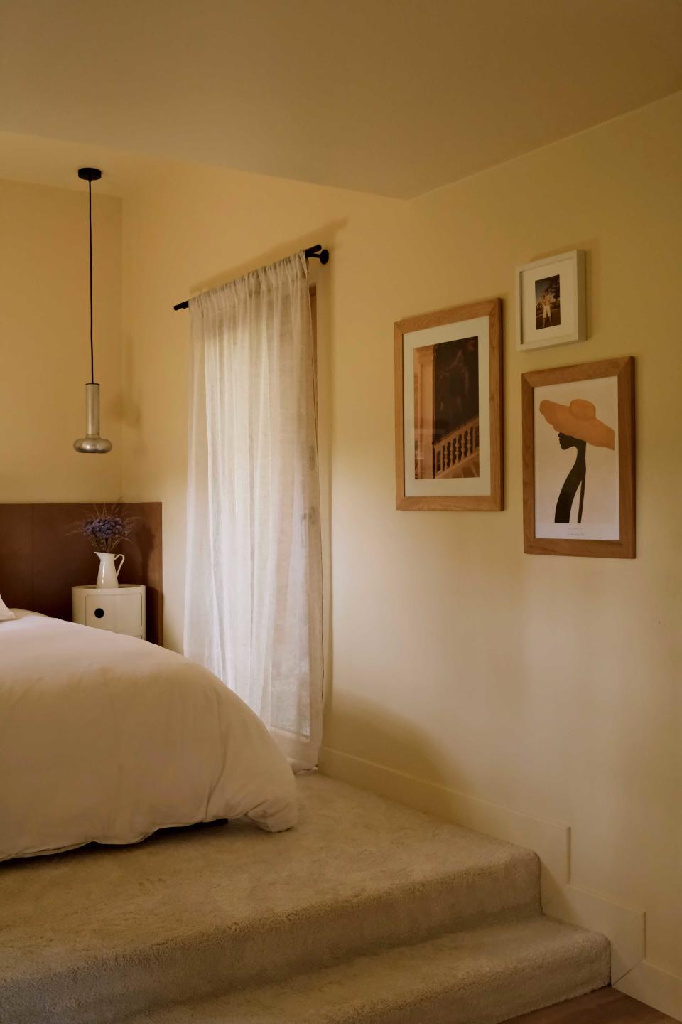 a small gallery wall in a bedroom