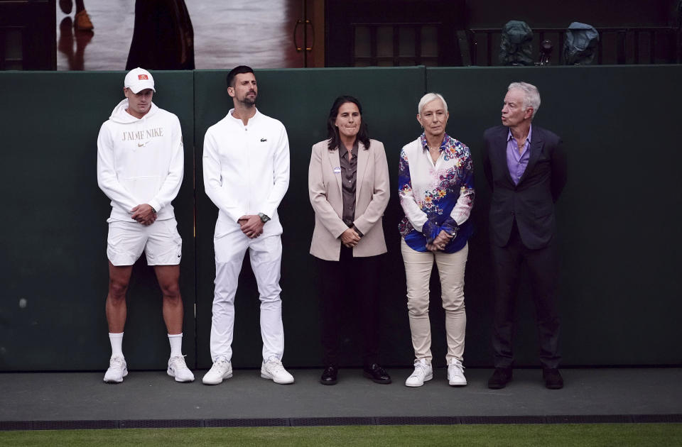 CAPTION CORRECTS ID Current and former players, from left, Holger Rune, Novak Djokovic, Conchita Martinez, Martina Navratilova, and John McEnroe listen to Britain's Andy Murray as he speaks with Sue Barker following his first round doubles match with this brother Jamie against Australia's John Peers and Ricky Hijikata at the Wimbledon tennis championships in London, Thursday, July 4, 2024. (John Walton/PA via AP)