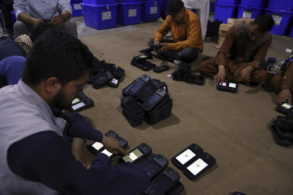 Election commission workers check biometric devices in preparation for the presidential election scheduled for Sept 28, at the Independent Election Commission compound in Kabul, Afghanistan, Sunday, Sept. 15, 2019. Afghan officials say around 100,000 members of the country's security forces are ready for polling day. (AP Photo/Rahmat Gul)