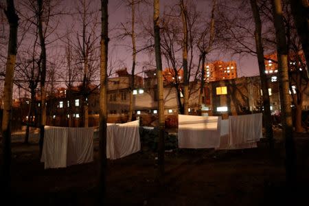 Laundry hangs on a clothes line in front of the accommodation where some patients and their family members stay while seeking medical treatment in Beijing, China, January 11, 2016. REUTERS/Kim Kyung-Hoon