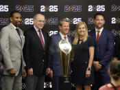From left, Atlanta Mayor Andre Dickens, College Football Playoff executive director Bill Hancock, Georgia Gov. Brian, Georgia first lady Marty Kemp, and SVP Chief Revenue Officer Tim Zulawski pose for a photograph with the CFP National Championship trophy during a press conference at Mercedes-Benz Stadium, Tuesday, Aug. 16, 2022, in Atlanta, announcing that the CFP National Championship NCAA college football game will be played at Mercedes-Benz Stadium in 2025. (Jason Getz/Atlanta Journal-Constitution via AP)