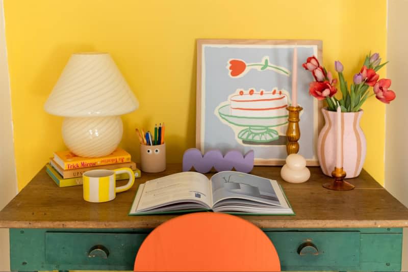Colorful art print on eclectic work desk.