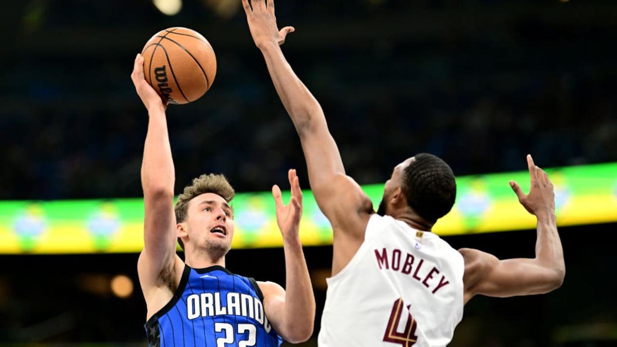 <div>ORLANDO, FLORIDA - MAY 03: Franz Wagner #22 of the Orlando Magic shoots the ball against Evan Mobley #4 of the Cleveland Cavaliers during the first quarter in Game Six of the Eastern Conference First Round Playoffs at Kia Center on May 03, 2024 in Orlando, Florida. (Photo by Julio Aguilar/Getty Images)</div>