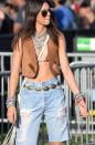 Kendall Jenner sports a new version of the boyfriend jean with baggy distressed shorts. She paired these with a bikini top, suede vest, and lots and lots of necklaces.