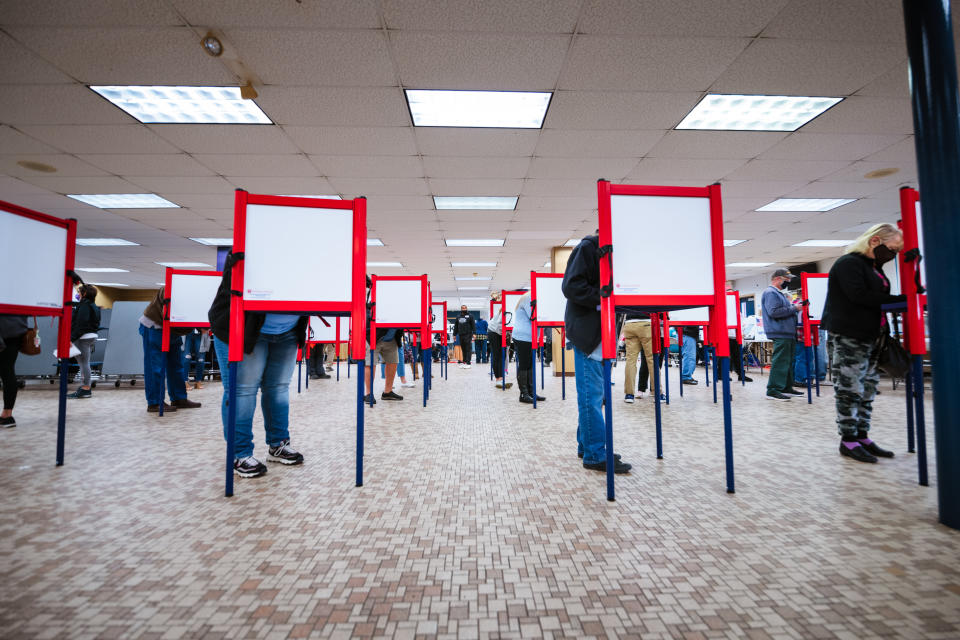 Voters stand at ballot boxes and cast their votes at Fairdale High School on Nov. 3, 2020, in Louisville. (Photo: Jon Cherry via Getty Images)