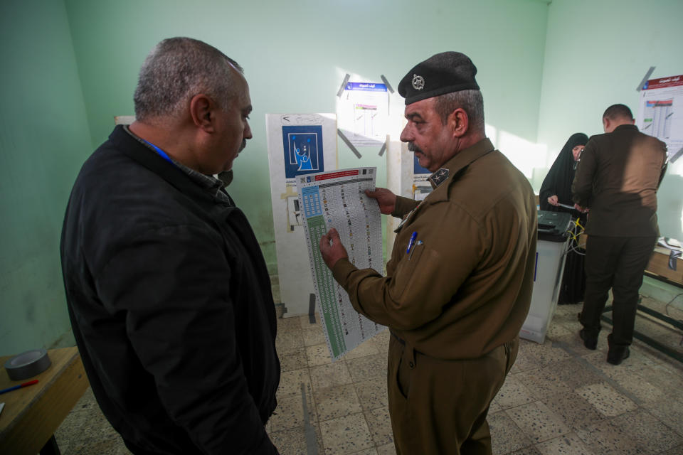 Iraqi security forces members participate in the provincial elections in Najaf, Iraq, Saturday, Dec. 16, 2023. (AP Photo/Anmar Khalil)