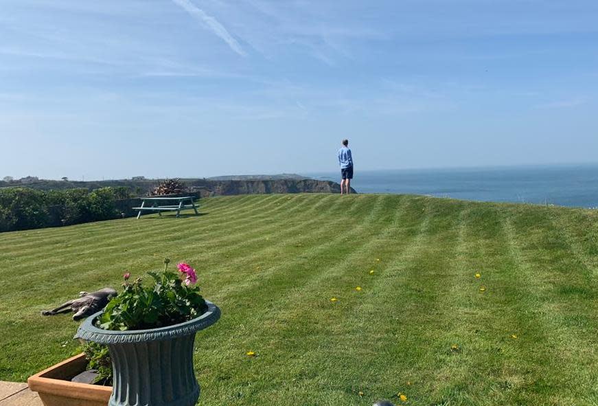 Nick Smith (pictured) at the end of his garden in Nefyn, North Wales, before the cliff fall took away 13ft off his property. (Yahoo UK/Courtesy of Nick Smith)