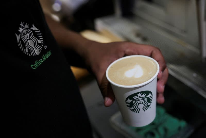 FILE PHOTO: An employee prepares a coffee drink at a Starbucks' outlet at a market in New Delhi