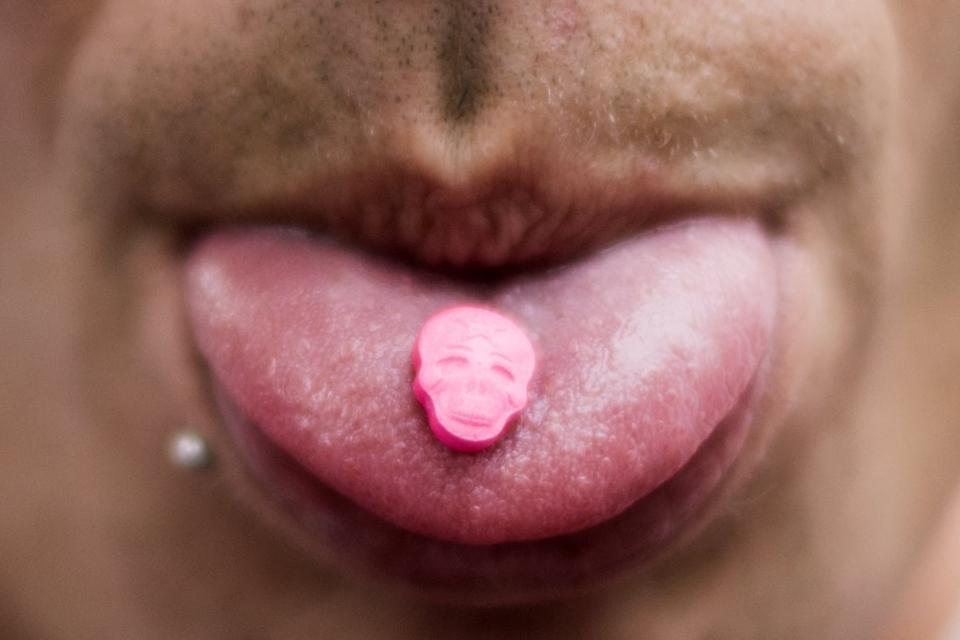 A pill on man's tongue. 