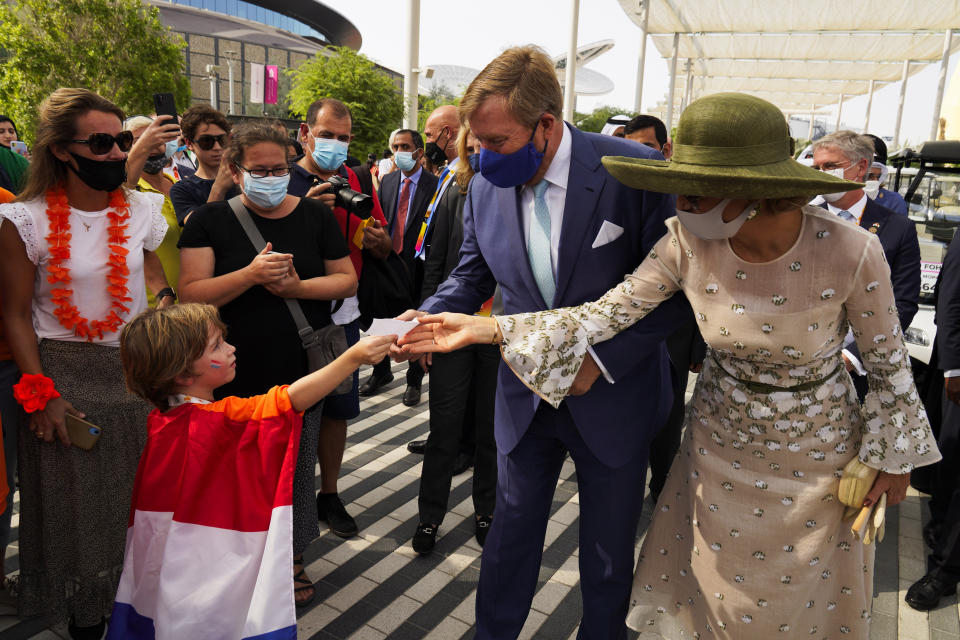 King Willem-Alexander and Queen Maxima receive a note from a young boy at Expo 2020 in Dubai, United Arab Emirates, Wednesday, Nov. 3, 2021. King Willem-Alexander and Queen Maxima of the Netherlands are in the United Arab Emirates as part of a royal trip to the country to visit Dubai's Expo 2020. (AP Photo/Jon Gambrell)