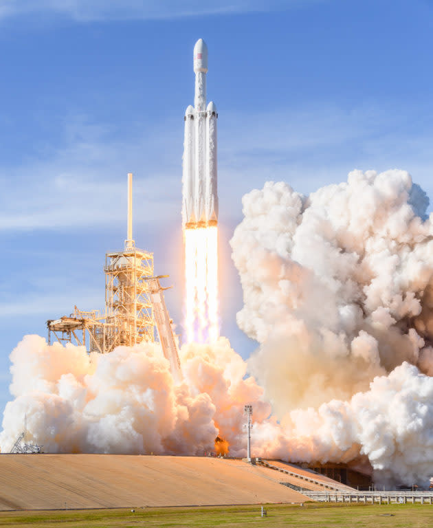 The SpaceX Falcon Heavy clears the tower at Kennedy Space Center in Florida. (GeekWire Photo / Kevin Lisota) <a href="https://www.geekwire.com/2018/spacex-launches-falcon-heavy-roadster/" rel="nofollow noopener" target="_blank" data-ylk="slk:Read the story.;elm:context_link;itc:0;sec:content-canvas" class="link "><strong>Read the story.</strong></a>