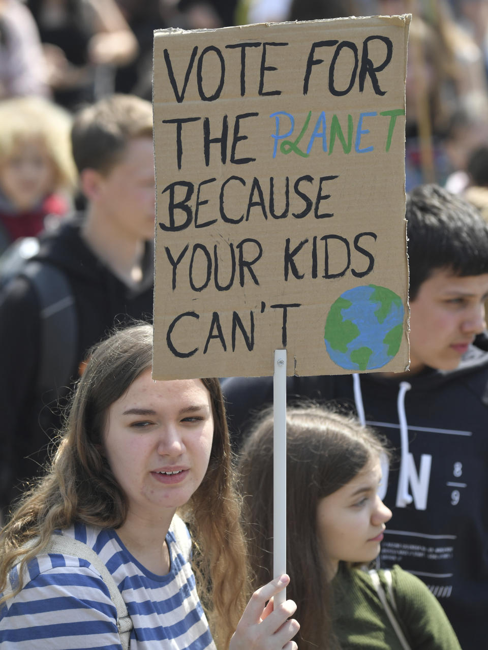 Young protestors hold a sign reading 'vote for the planet because your kids can't' ahead of the European elections during a climate strike of school students as part of the Fridays for Future movement in Frankfurt, Germany, Friday, May 24, 2019. (Boris Roessler/dpa via AP)