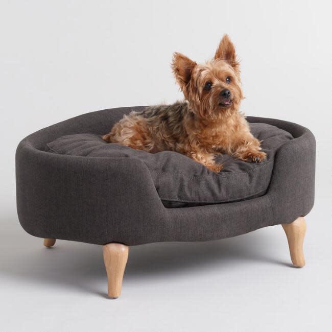 Charcoal Gray Upholstered Lola Pet Bed With Wood Legs (Photo: Wayfair)