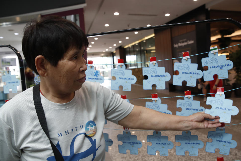 A family members of passengers on board from China of the missing Malaysia Airlines Flight 370 holds the names tag of the missing passenger during the tenth annual remembrance event at a shopping mall, in Subang Jaya, on the outskirts of Kuala Lumpur, Malaysia, Sunday, March 3, 2024. Ten years ago, a Malaysia Airlines Flight 370, had disappeared March 8, 2014 while en route from Kuala Lumpur to Beijing with 239 people on board. (AP Photo/FL Wong)
