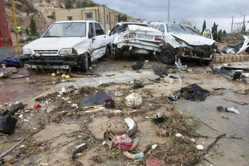 A child's doll lies in front of destroyed cars after a flash flood in the southern city of Shiraz, Iran, Monday, March 25, 2019. Flash floods in southern Iran have killed at least 17 people and injured scores, Iranian state TV reported on Monday. The northern provinces of Golestan and Mazandaran have been struggling with flooding for over a week, and five people have been killed, according to the state-run Press TV channel. (AP Photo/ISNA)
