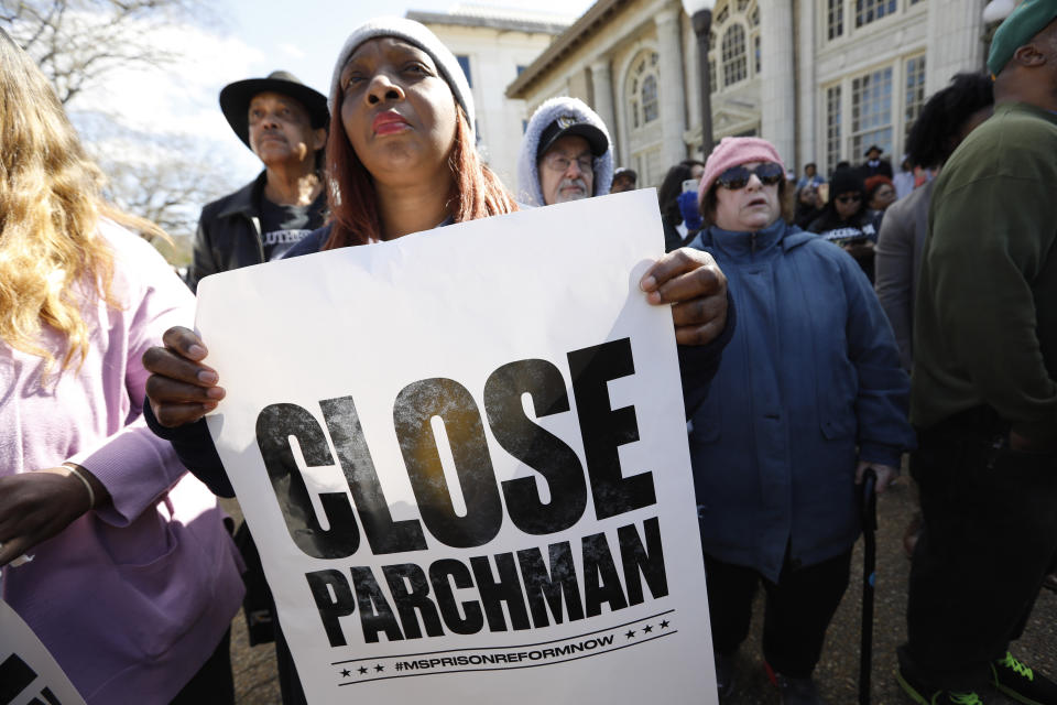 Many attendees of a rally at the Mississippi Capitol in Jackson, carried signs that protested conditions in prisons where inmates have been killed in violent clashes in recent weeks, Friday, Jan. 24, 2020. They called upon the administration to specifically close the Mississippi State Penitentiary in Parchman, where a number of deaths have occurred. (AP Photo/Rogelio V. Solis)