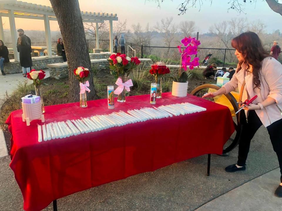 Oakdale resident Michelle Alva, 28, sets up a table at a vigil Jan. 22, 2022, honoring her friend Rebekah Gall, 27, who was killed in a car crash by a drunken driver.