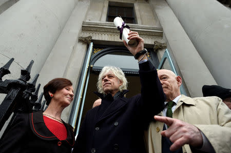Bob Geldof arrives to return his 'Freedom of the City of Dublin' with local councillor Mannix Flynn and Oonagh Casey of Dublin's City Manager's office, after saying he could not continue to hold the honour with Myanmar leader Aung San Suu Kyi, in Dublin, Ireland, November 13, 2107. REUTERS/Clodagh Kilcoyne