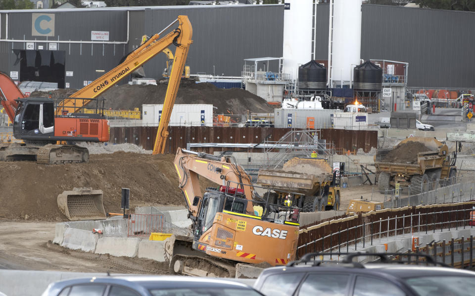 Heavy machinery work at a major road project in Sydney, Australia, Tuesday, May 11, 2021. The Australian government will release its big-spending economic plan for the next fiscal year on Tuesday designed to create jobs and repair pandemic damage and with an eye toward winning votes at looming general elections. (AP Photo/Mark Baker)