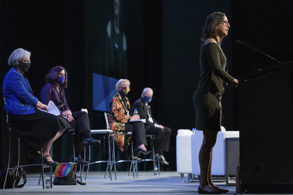 In this Monday, Oct. 18, 2021 photo, Michele Rosenthal, right, gives opening remarks at the Eradicate Hate Global Summit in Pittsburgh. Rosenthal's brothers, Cecil and David Rosenthal, were killed in the Oct. 27, 2018, mass shooting at the Tree of Life synagogue. Seated from left are Kathleen Blee, Lorrie Cranor, Laura Ellsworth and Rabbi Hazzan Jeffrey Myers, who also gave opening remarks at the summit. (AP Photo/Rebecca Droke)