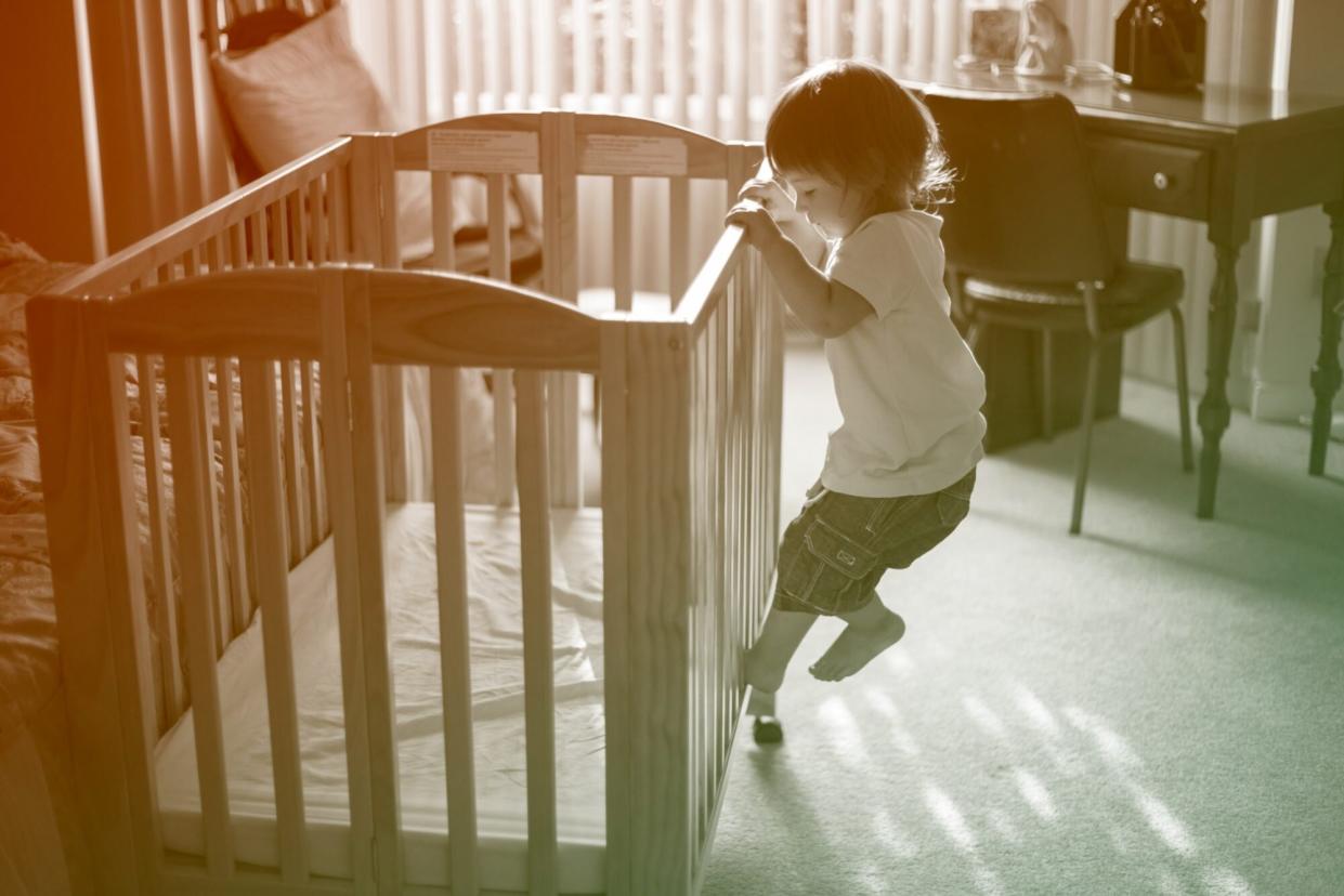 toddler climbing out of crib