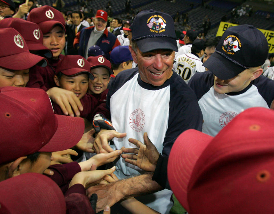 Chiba Lotte Marines manager Bobby Valentine is surrounded by Japanese children before a friendly baseball game between U.S. embassy employees and Japan's ruling Liberal Democratic Party's freshmen at Tokyo Dome in Tokyo March 15, 2006. REUTERS/Yuriko Nakao