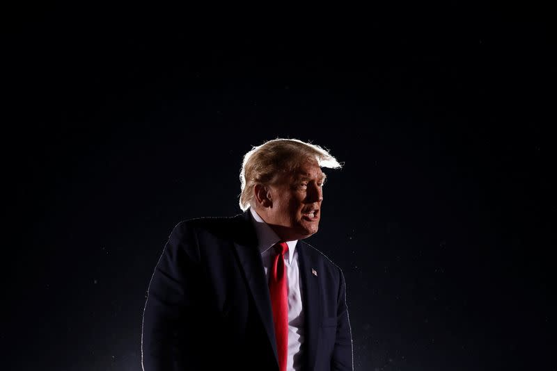 U.S. President Donald Trump reacts as he leaves after his campaign rally at Middle Georgia Regional Airport in Macon, Georgia, U.S.