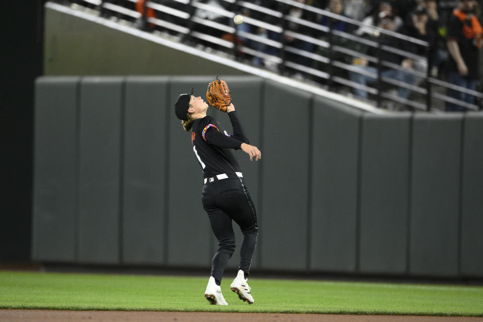 Baltimore Orioles second baseman Jackson Holliday prepares to make a catch on a fly ball by Milwaukee Brewers' Gary Sánchez during the third inning of a baseball game Friday, April 12, 2024, in Baltimore. (AP Photo/Nick Wass)