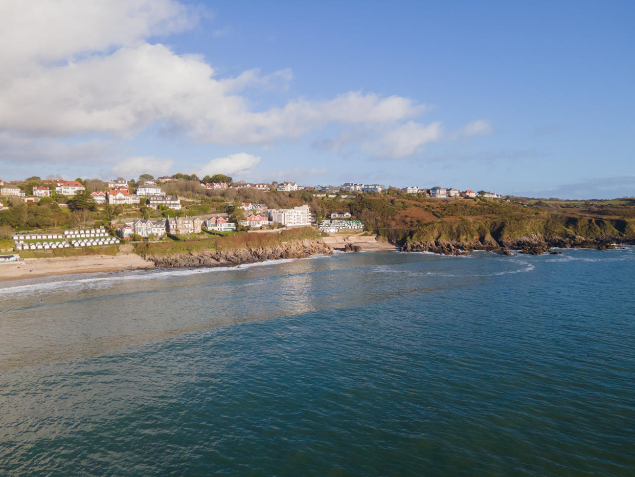 Looking Into Langland Bay in Gower, Wales, UK from the sea on a clean late Autumn day. Blue skies with some clouds