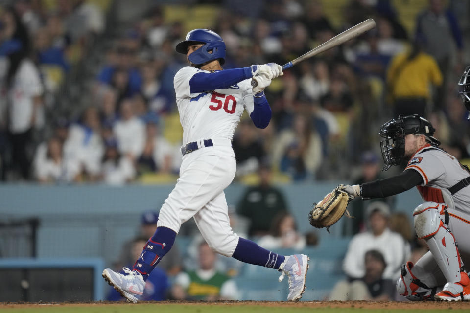 Los Angeles Dodgers' Mookie Betts (50) doubles during the eighth inning of a baseball game against the San Francisco Giants in Los Angeles, Saturday, Sept. 23, 2023. David Peralta and Austin Barnes scored.(AP Photo/Ashley Landis)